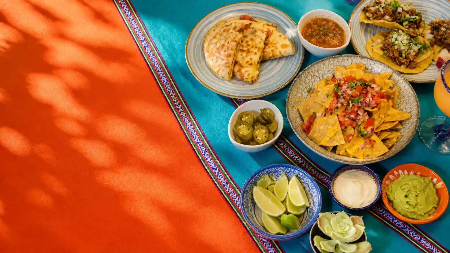 A colorful Mexican feast of tacos, salsas, lime, and guacamole